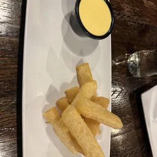 a plate of french fries and dipping sauce