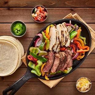 a steak fajitta with peppers and onions