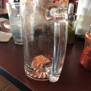 a glass of beer with a saucer in the background