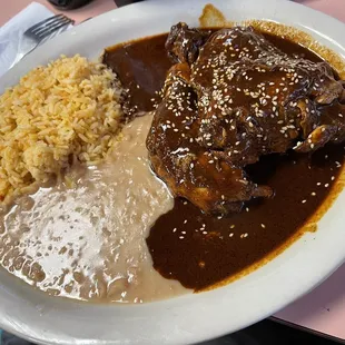 Pollo en mole rojo. Chicken with red mole sauce.