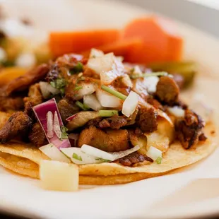 Al pastor, is a preparation of Rotisserie grilled bbq pork. The method of preparing and cooking al pastor is based on the lamb shawarma!