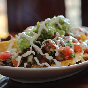 Our Super Nachos made with choice of meat, beans, cheese, sour cream, guacamole, and pico de gallo.
