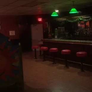 a bar with red stools