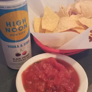 Chips and salsa with hard seltzer while waiting for my family to arrive.