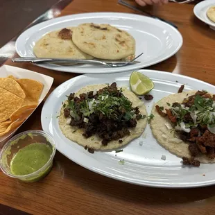 Pork and cheese pupusas, al pastor and asada tacos