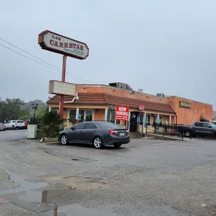 a car parked in front of a restaurant