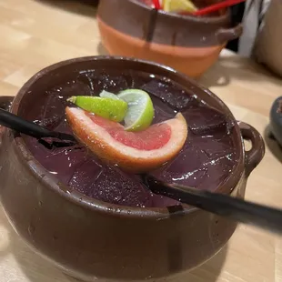 a close up of a chocolate bowl with a grapefruit and lime garnish