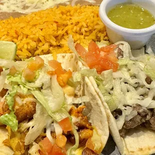 Chicken and steak taco with rice and beams