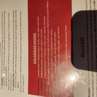 Menu describing the chilaquiles you can order. Chilaquiles Smoky Chipotle, savory pablano, garlic tomato flight I tried mmmmmmm