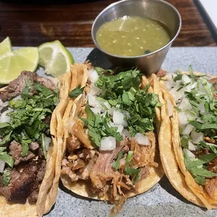 Steak, carnitas and pastor taco on corn tortillas