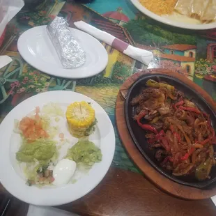 Steak fajitas lunch special (11am-3pm) with guacamole salad and corn on the cob sides and corn tortillas (in foil)