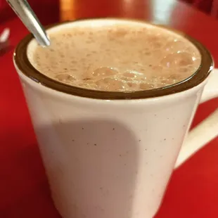 a cup of coffee with a spoon in it