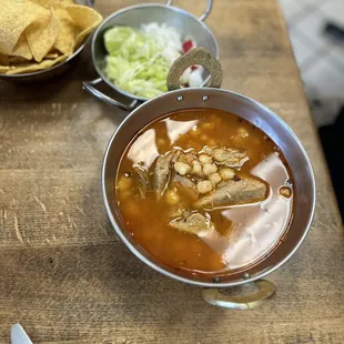 a bowl of soup with tortillas and tortillas