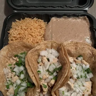 Chicken tacos on corn with rice and beans