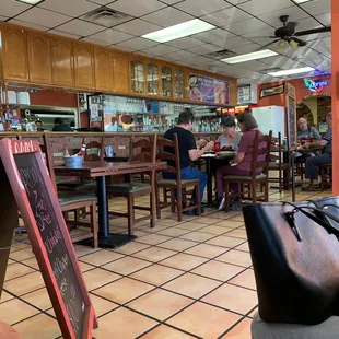 people sitting at tables in a restaurant