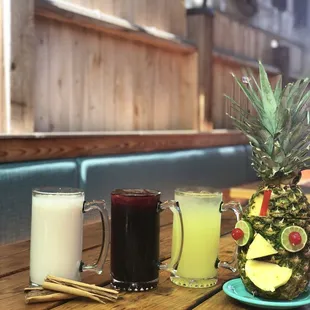  a pineapple, a pineapple juice, and a smoothie