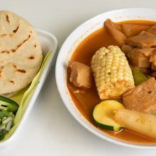 a bowl of soup and a tortilla