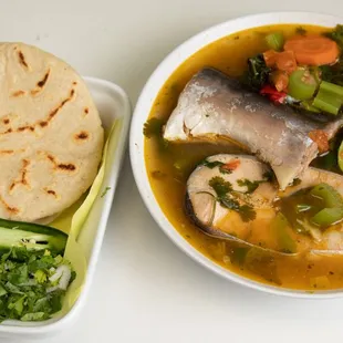 a bowl of soup and a tortilla