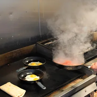 a woman cooking in a kitchen