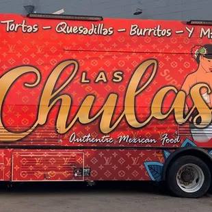 a colorful food truck parked in front of a building