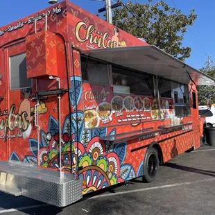 a colorful food truck parked in a parking lot