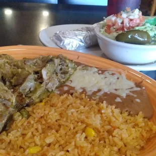 Pork carnitas Rice and beans Guacamole salad.