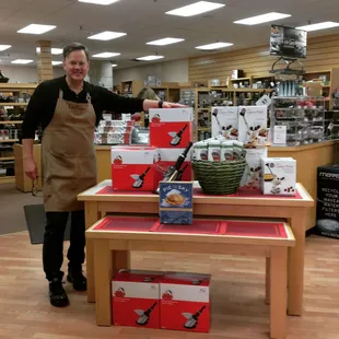a man standing in front of a display of kitchen supplies