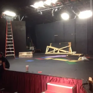 a stage with a man on a ladder