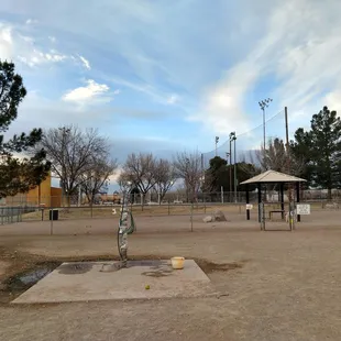 Water pump in front of the small section of the dog park.