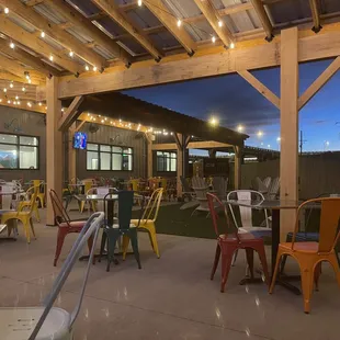 a patio with tables and chairs