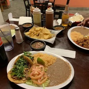Taco plate with barbacoa and carnitas tacos, rice and beans