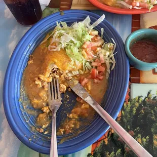 a plate of enchiladas and a drink