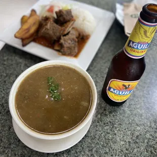 a bowl of soup and a bottle of beer