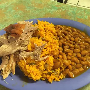 Lechon asado, arroz con gandules, and habichuela/ roasted pork with rice and beans