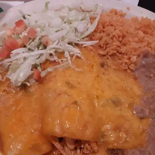 Mix enchilada plate cheese, chicken,  and beef.