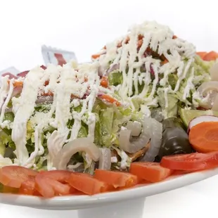 a white plate with a salad on it