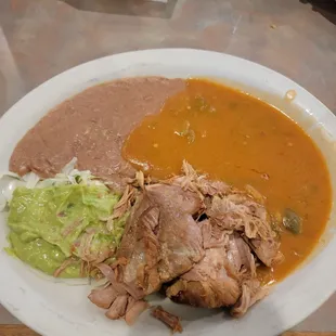 Carnitas, with beans and guacamole,  and green chili