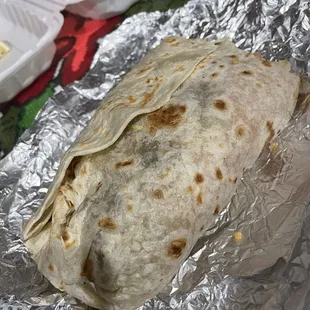 a burrito wrapped in aluminum foil