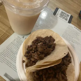 Horchata and 2 tacos de carne asada plain pretty good portions of meat