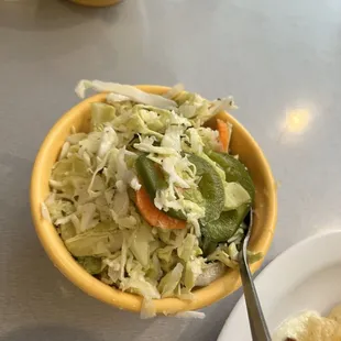 a bowl of salad and tortillas