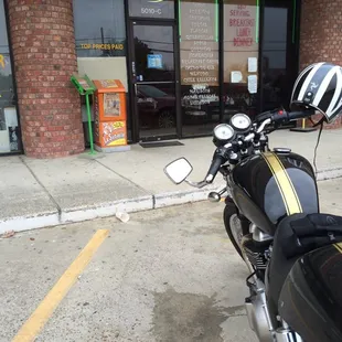 a motorcycle parked in front of a restaurant