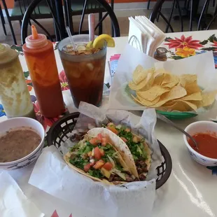 Beef fajita tacos with a side of beans for lunch.