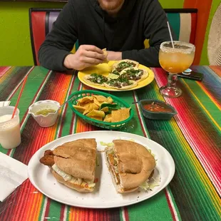 a man sitting at a table with a plate of food