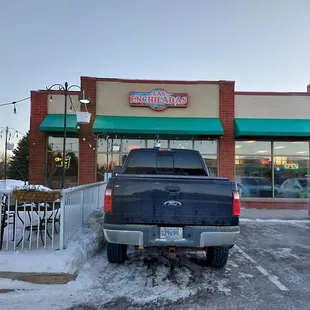 a truck parked in front of a restaurant