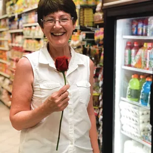 Mother's Day rose, in front of beverages and food items