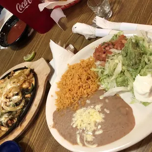 Cheesy Poblano Fajitas w beef, chicken and Shrimp. The onions are like candy so we always ask for extra!