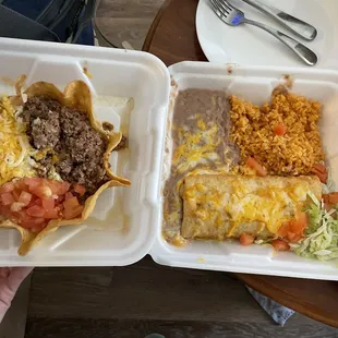 Left: ground beef taco salad. Right: shredded beef chimichanga with green chili on side (separate container further right)