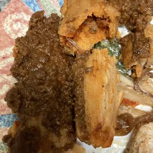 Pork tamales covered in chorizo sauce? Veggie tamales with tomatillo sauce were listed on the menu and originally ordered.