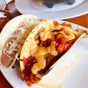 A Grilled Shrimp (Cameron) with Chipotle Crema and a Refried Bean (Frijoles De Casa) Taco