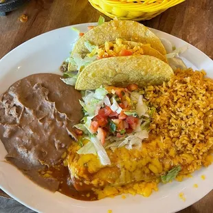 Two crispy beef tacos, picadillo enchilada, beans and rice.